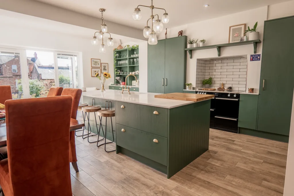 A kitchen island unit with breakfast stools around it