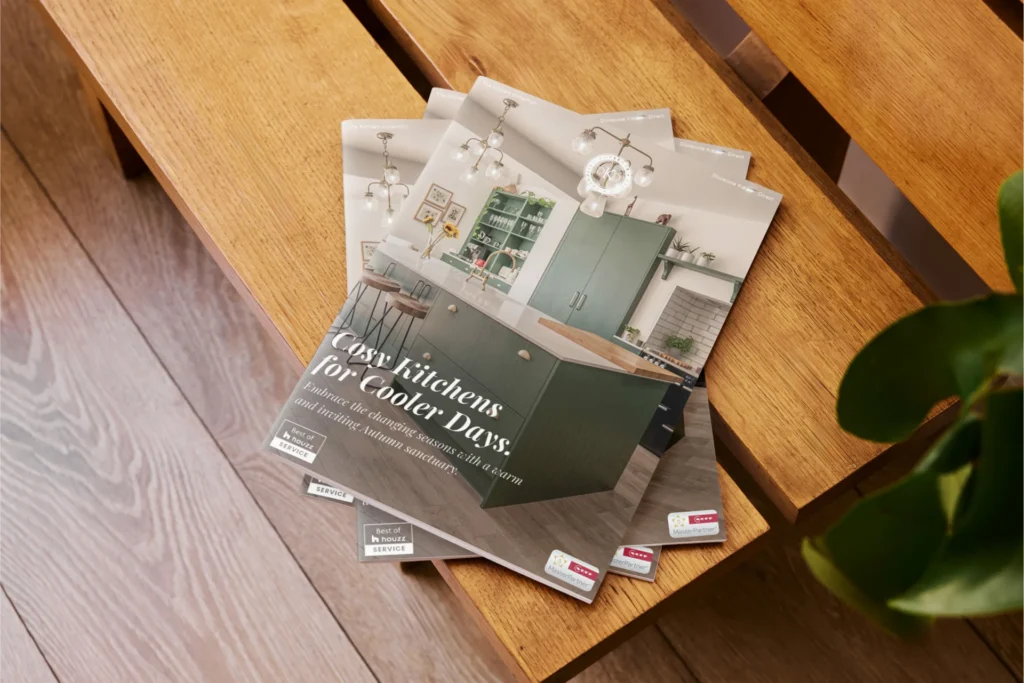 Designer Kitchen Direct printed brochures fanned out on a wooden bench